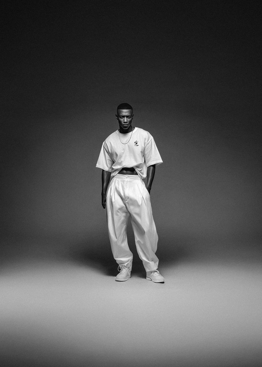 Person wearing a white outfit with a dark background